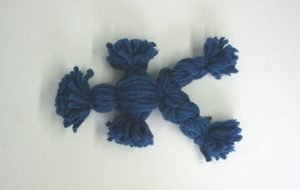 Legs formed on yarn doll
