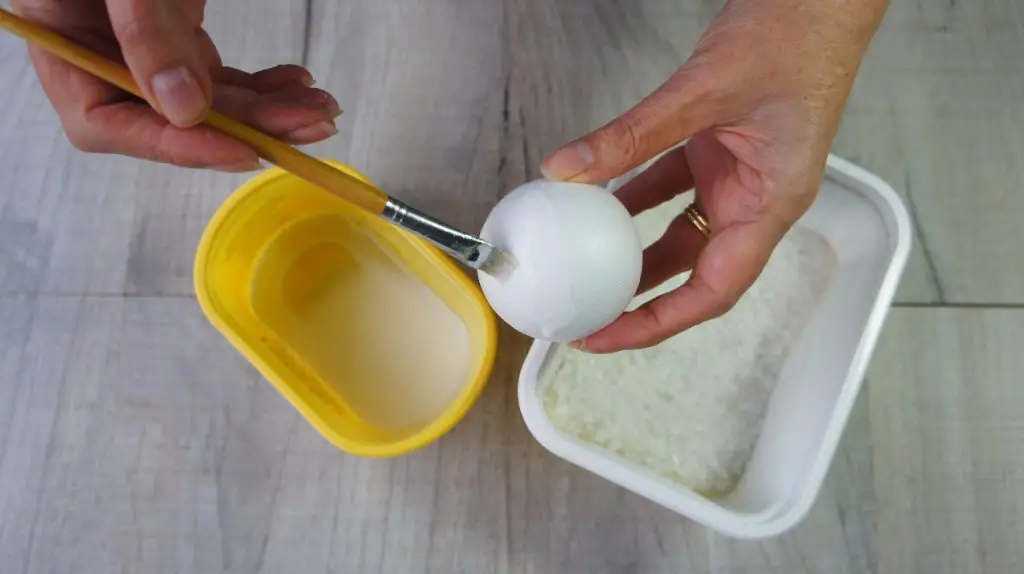 applying glue to ball