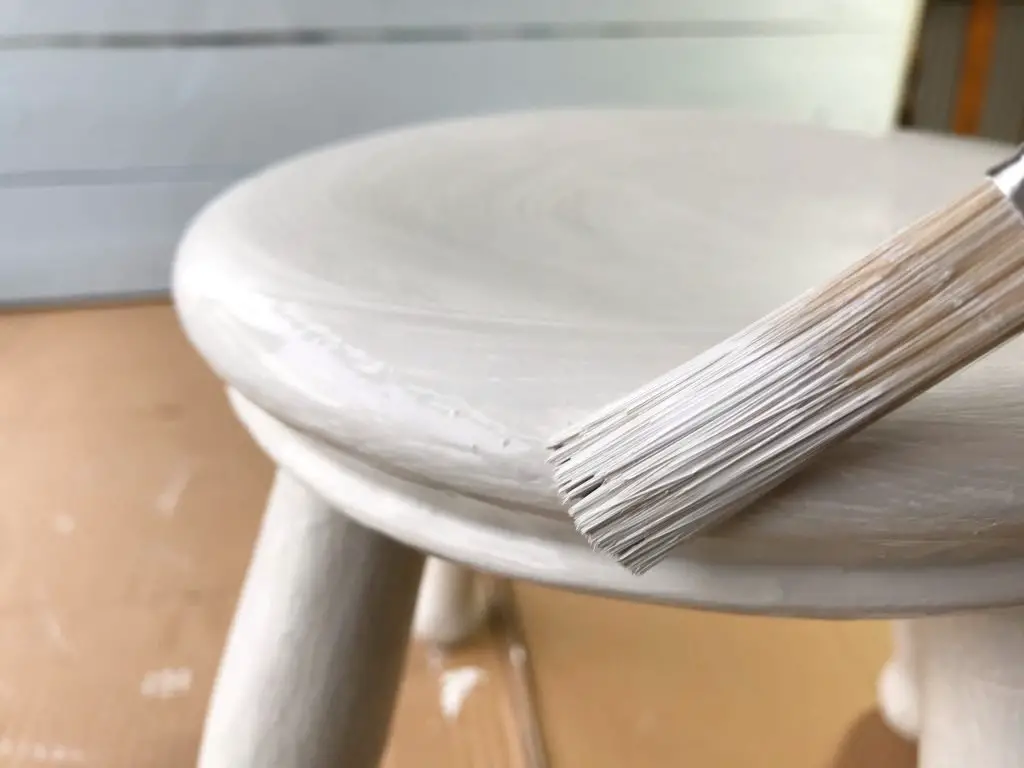 painting grey onto wooden stool top