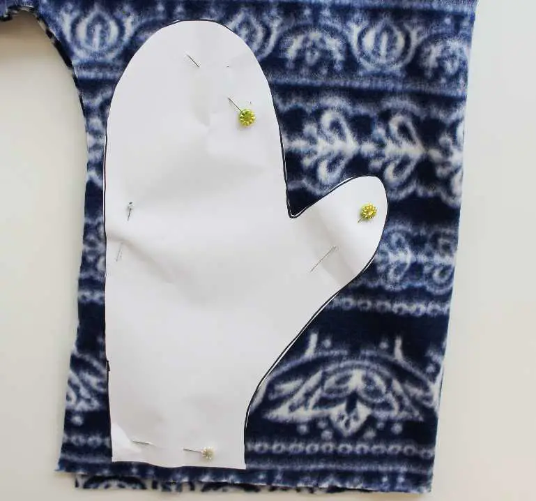 mitten pattern pinned to fleece fabric