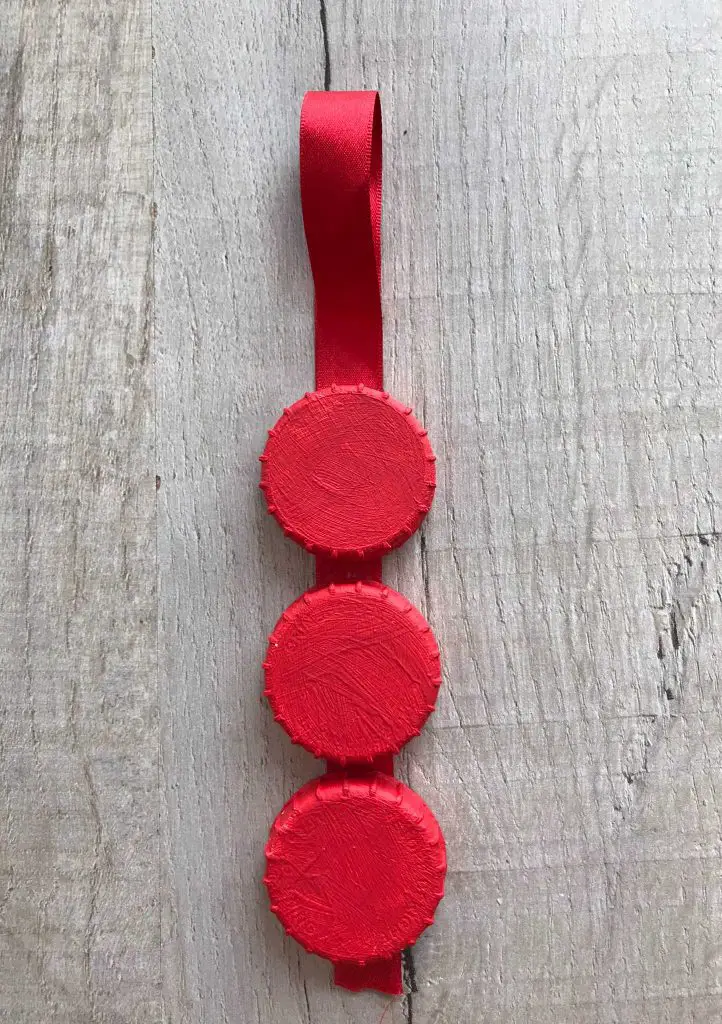 red bottle tops on ribbon with loop