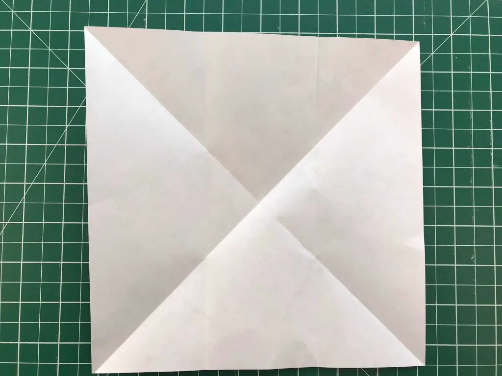 square of paper folded in half both ways and opened out