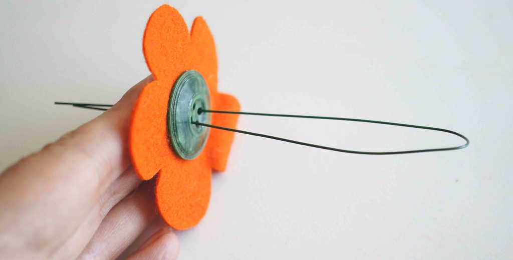 wire being inserted for felt button flower