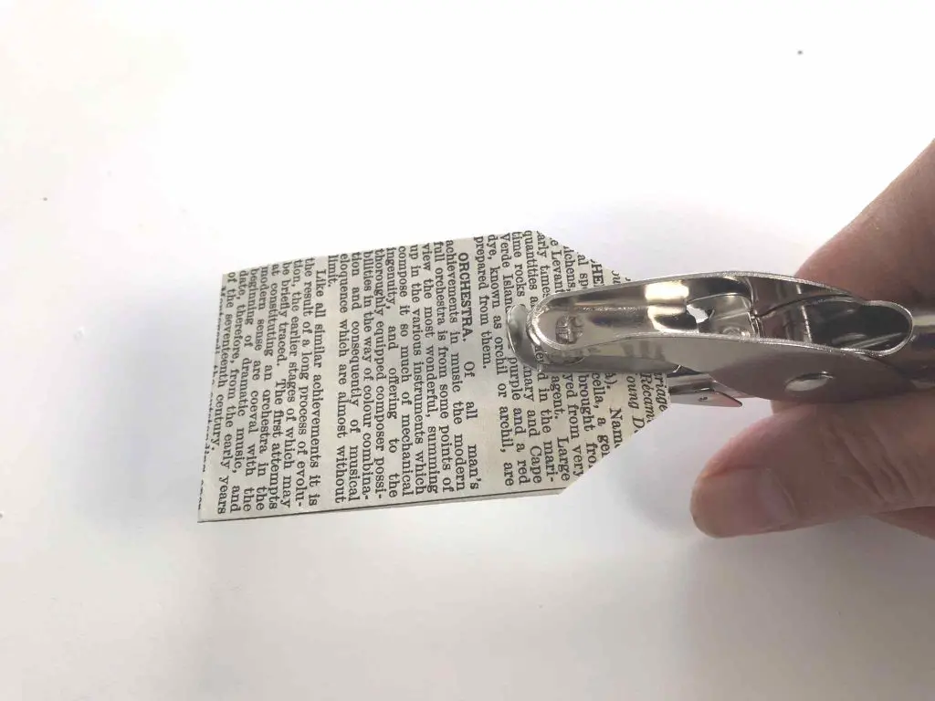 book page gift tag being punched