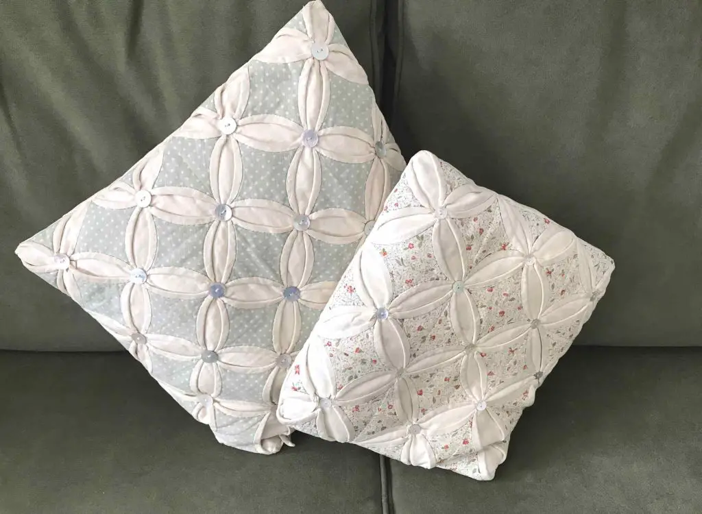 two cathedral window patchwork cushions