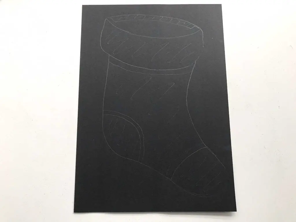 Christmas stocking drawn on black paper