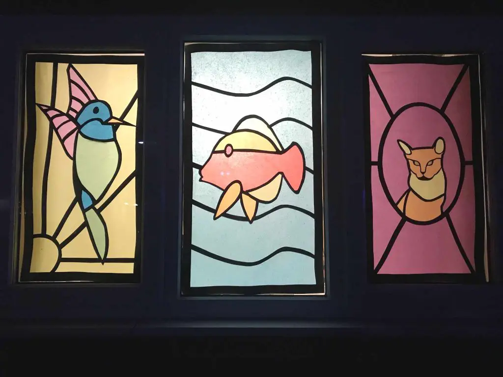 stained glass bird, fish and fox tableau