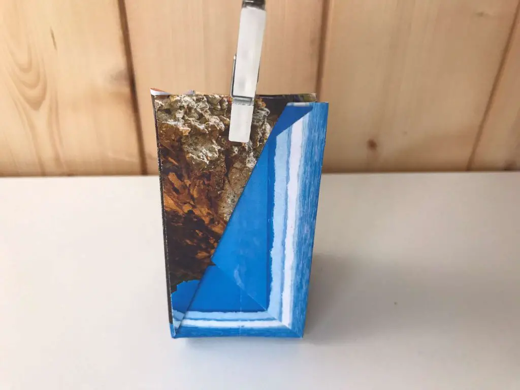 blue origami gift bag with pin to close